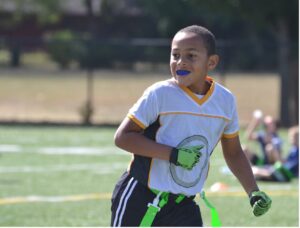Young person playing sports wearing a mouthguard