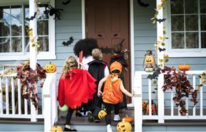 A group of kids in clothing on a porch of a house, Spooktacular Halloween Smiles with Braces: Tips for Braces-Friendly Halloween Candy