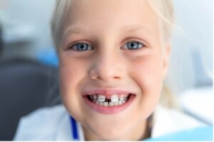 A close-up of a child smiling, Why is My Child Missing a Permanent Tooth?