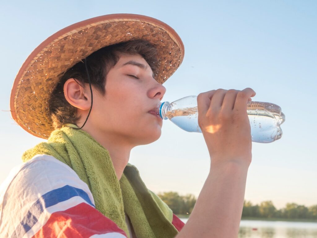 A person drinking from a bottle, Stay Hydrated and Healthy