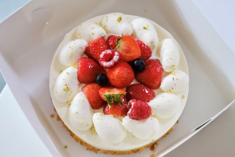 A Japanese-style strawberry shortcake with fresh cream, strawberries, raspberries and blueberries in a white cake box from Maki’s Patisserie in Sydney, Australia