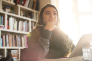 A person sitting at a desk with a pen and paper, Dream It, Smile It: Setting Orthodontic Goals for the New Year