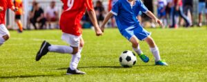 Playing Sports Safely with Braces: Ortho-Specialist Tips for an All-Star Smile, Kids playing soccer