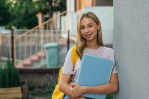 School-Friendly Orthodontic Options: A Smart Start for the School Year, A young girl with her school books